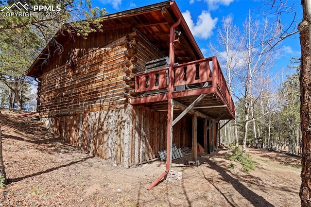 back of property featuring a wooden deck and log siding