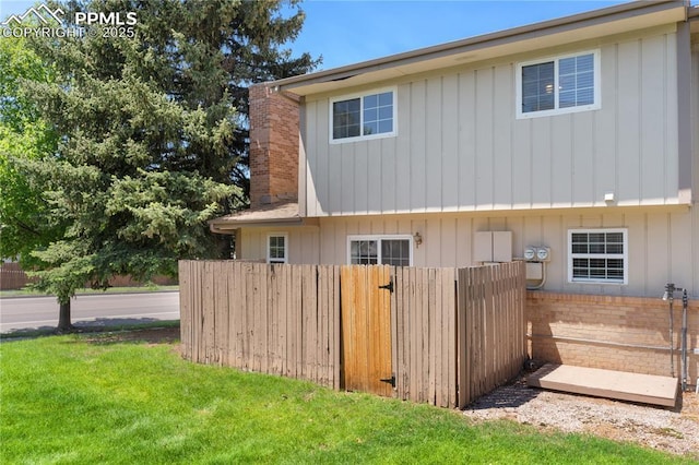 1187 Willow Bend Cir Unit A # 4, Colorado Springs, CO 80918 - view of property exterior featuring a chimney, board and batten siding, and brick siding