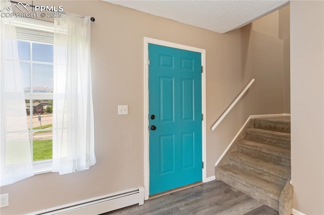 1187 Willow Bend Cir Unit A # 4, Colorado Springs, CO 80918 - foyer entrance with a baseboard heating unit, wood finished floors, stairway, and a textured ceiling