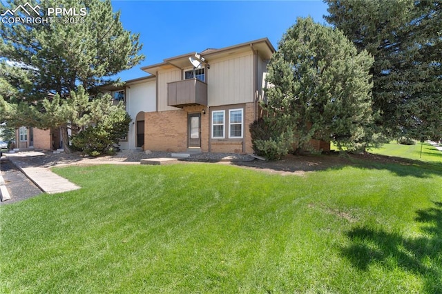 1187 Willow Bend Cir Unit A # 4, Colorado Springs, CO 80918 - view of front of home featuring a balcony, brick siding, and a front lawn