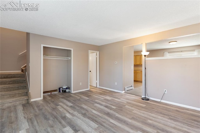 1187 Willow Bend Cir Unit A # 4, Colorado Springs, CO 80918 - unfurnished bedroom with a baseboard radiator, light wood finished floors, and a closet