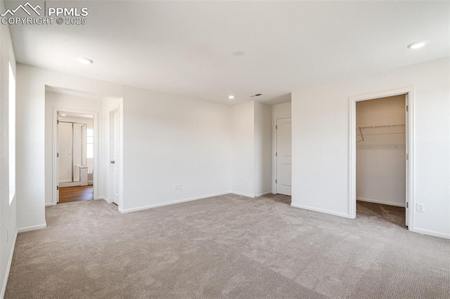 1821 Water Birch Way, Castle Rock, CO 80108 - unfurnished bedroom with carpet flooring, a spacious closet, baseboards, and recessed lighting
