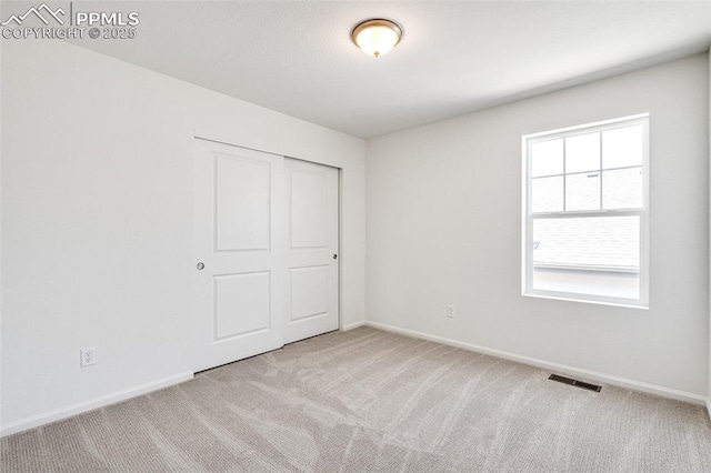 1821 Water Birch Way, Castle Rock, CO 80108 - unfurnished bedroom with baseboards, visible vents, a closet, and carpet floors