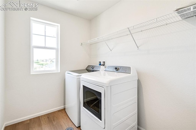 1821 Water Birch Way, Castle Rock, CO 80108 - laundry room featuring baseboards, washing machine and dryer, light wood-style flooring, and laundry area