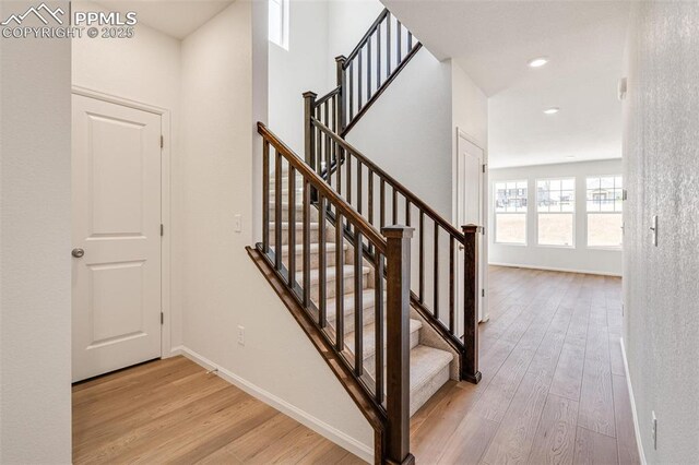 1821 Water Birch Way, Castle Rock, CO 80108 - stairs featuring recessed lighting, baseboards, and wood finished floors