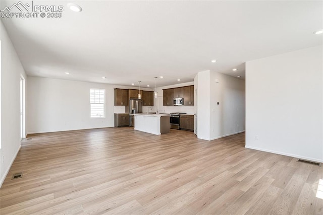 1821 Water Birch Way, Castle Rock, CO 80108 - unfurnished living room with visible vents, light wood-style floors, and recessed lighting
