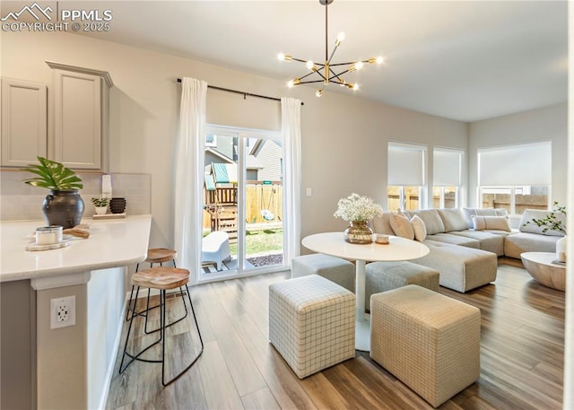 living room featuring a chandelier and wood finished floors