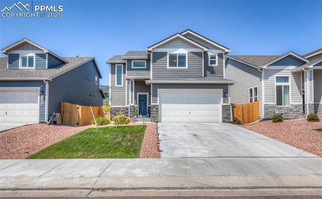 craftsman-style house featuring a front yard, stone siding, concrete driveway, fence, and an attached garage