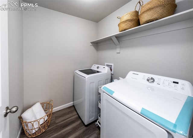 washroom featuring independent washer and dryer, baseboards, laundry area, and dark wood finished floors