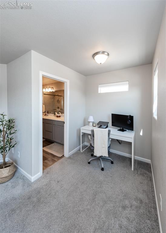 home office with baseboards and carpet floors