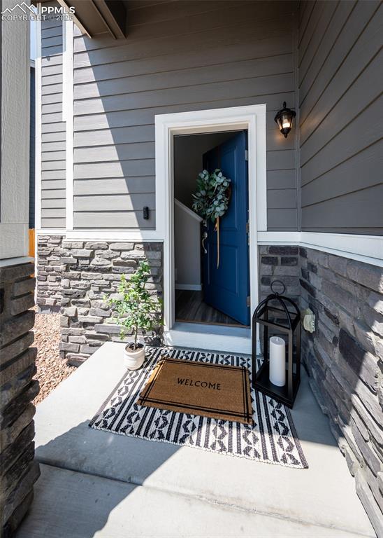 entrance to property featuring stone siding