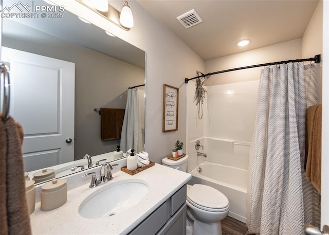 bathroom with visible vents, toilet, wood finished floors, vanity, and shower / bath combination with curtain