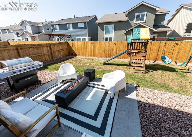 view of patio featuring an outdoor fire pit, a residential view, a fenced backyard, and a playground