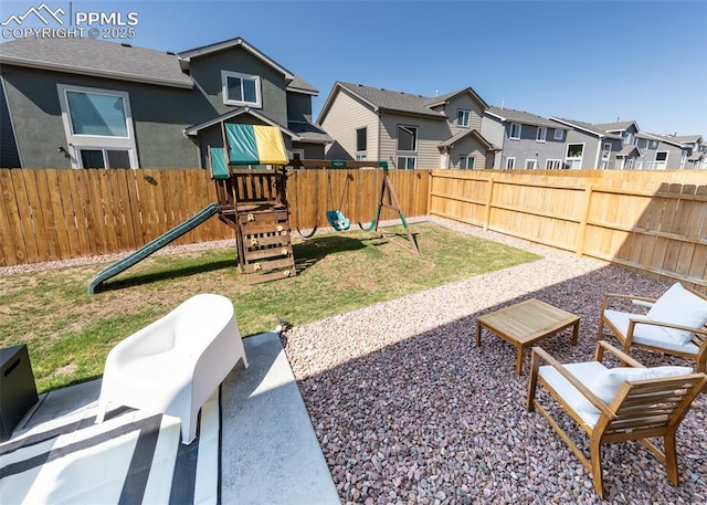 view of yard with a fenced backyard, a residential view, a patio area, and a playground