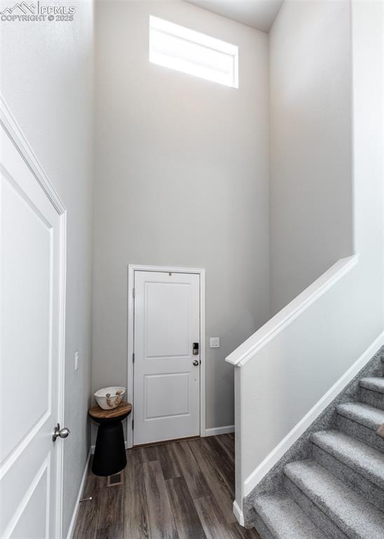 stairway with baseboards and wood finished floors