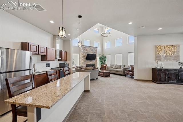 10713 Traders Pkwy, Fountain, CO 80817 - kitchen featuring recessed lighting, light colored carpet, stainless steel appliances, a kitchen island, and visible vents