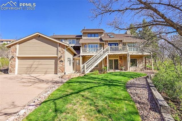 view of front facade featuring a deck, a front yard, stairs, concrete driveway, and a chimney