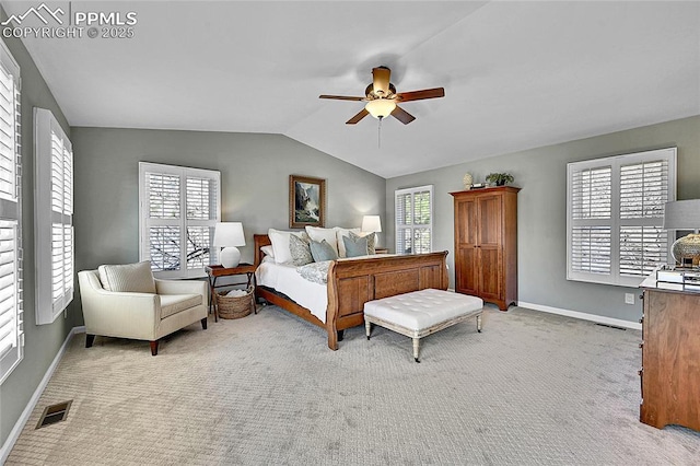 carpeted bedroom featuring lofted ceiling, baseboards, and a ceiling fan