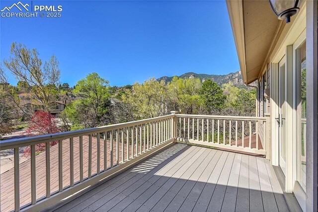 wooden deck with a mountain view