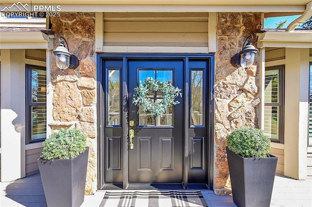 doorway to property with stone siding