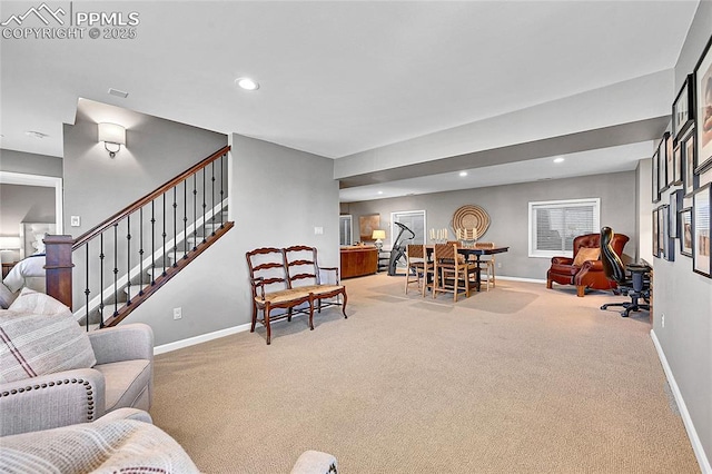 living room featuring baseboards, light carpet, recessed lighting, and stairs