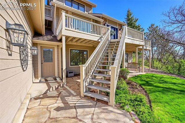 doorway to property with a wooden deck and a patio