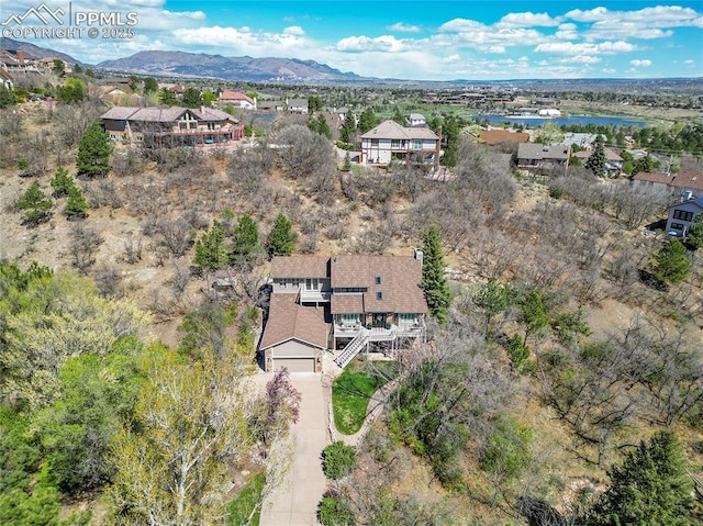 aerial view of residential area featuring a water and mountain view
