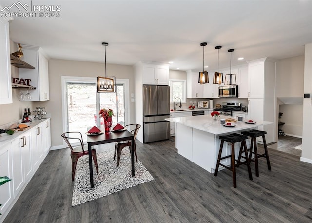 1021 Pioneer Ln, Colorado Springs, CO 80904 - kitchen with stainless steel appliances, open shelves, a sink, white cabinets, and dark wood finished floors