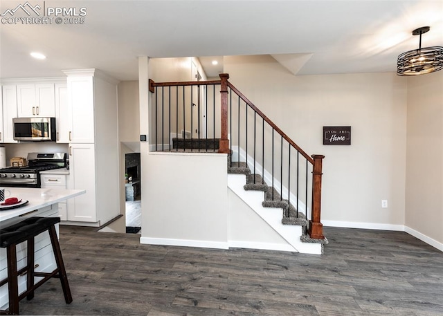 1021 Pioneer Ln, Colorado Springs, CO 80904 - stairway featuring wood finished floors, baseboards, and recessed lighting