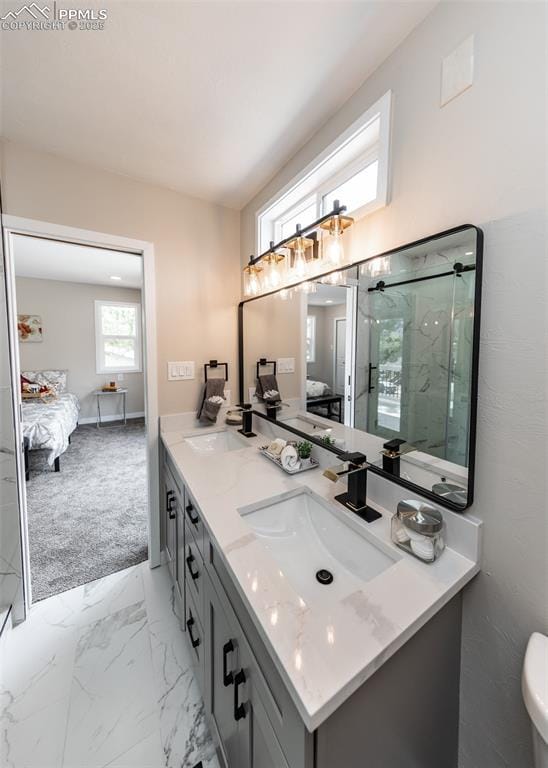 1021 Pioneer Ln, Colorado Springs, CO 80904 - ensuite bathroom with a marble finish shower, double vanity, and marble finish floors