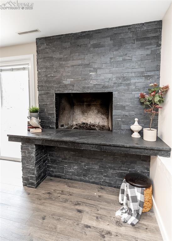 1021 Pioneer Ln, Colorado Springs, CO 80904 - detailed view of wood finished floors, baseboards, and a fireplace