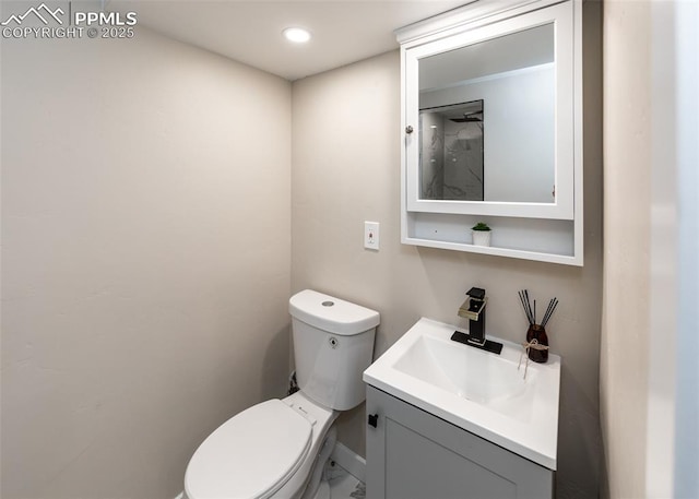 1021 Pioneer Ln, Colorado Springs, CO 80904 - bathroom with toilet, vanity, baseboards, and marble finish floors