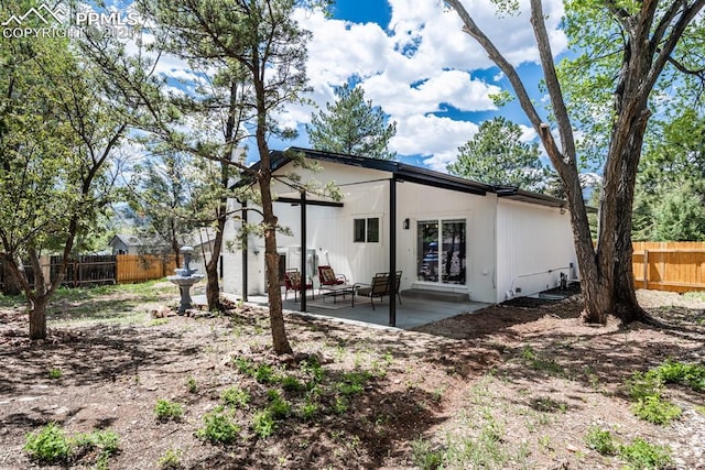 1021 Pioneer Ln, Colorado Springs, CO 80904 - rear view of house with fence and a patio