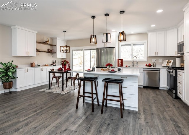 1021 Pioneer Ln, Colorado Springs, CO 80904 - kitchen featuring appliances with stainless steel finishes, dark wood-type flooring, healthy amount of natural light, white cabinets, and recessed lighting