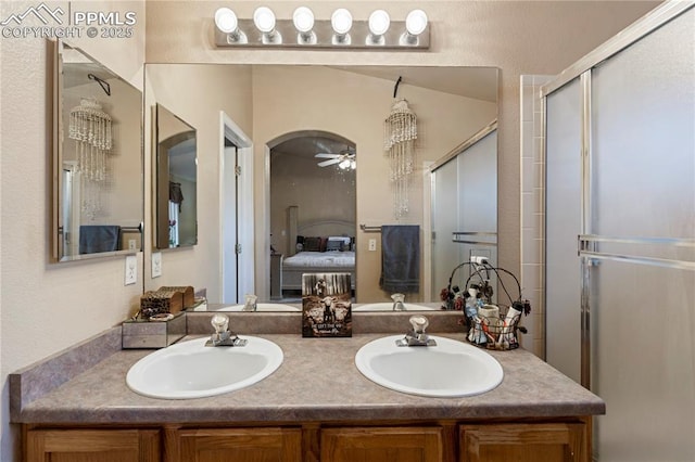 full bathroom with connected bathroom, a sink, a ceiling fan, and a shower stall