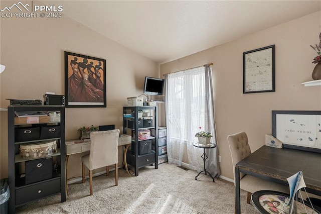 carpeted home office featuring baseboards and lofted ceiling