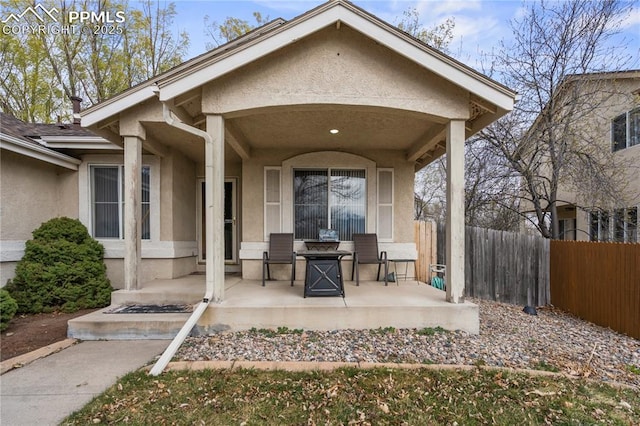 view of patio featuring fence