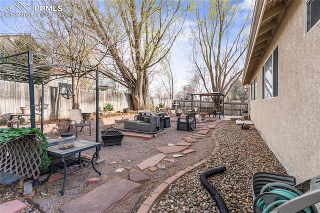view of yard with an outdoor fire pit, a fenced backyard, and a patio