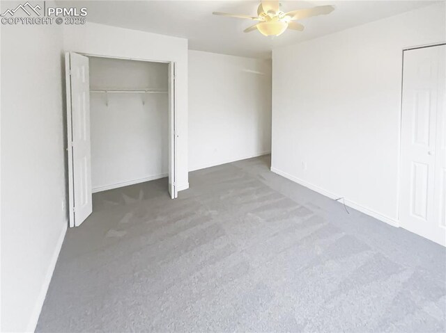 unfurnished bedroom with carpet flooring, a ceiling fan, and baseboards