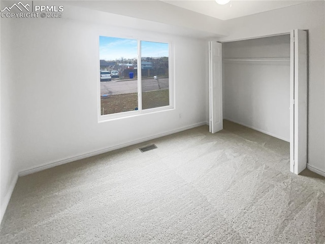 unfurnished bedroom with a closet, baseboards, and visible vents