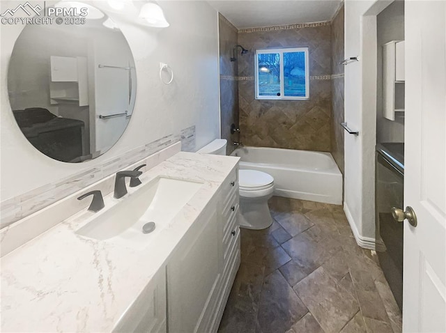bathroom featuring toilet, vanity, and shower / bath combination