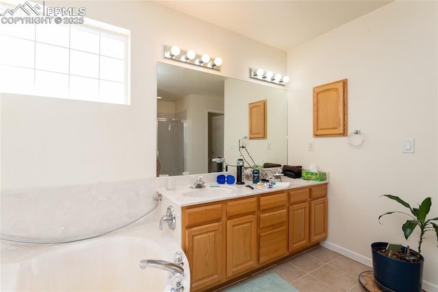 full bath featuring a sink, double vanity, tile patterned floors, a stall shower, and a garden tub