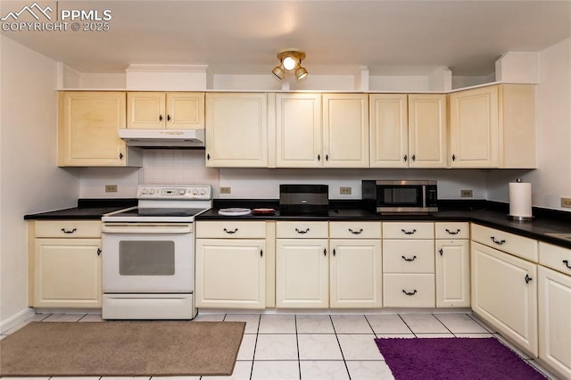 kitchen with dark countertops, stainless steel microwave, white range with electric stovetop, and under cabinet range hood