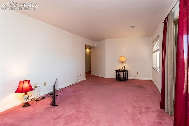 carpeted empty room with baseboards and visible vents