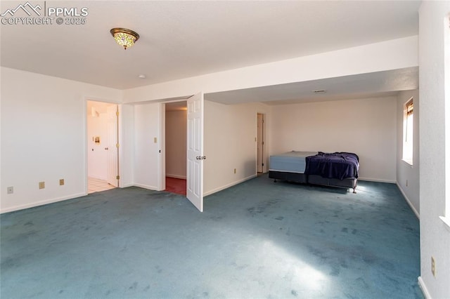 unfurnished bedroom featuring carpet flooring and baseboards