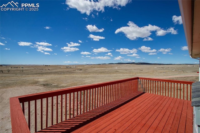 wooden deck featuring a rural view