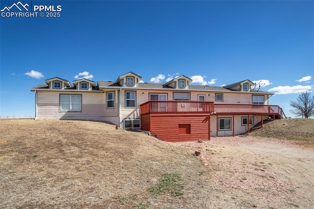 rear view of property with a wooden deck