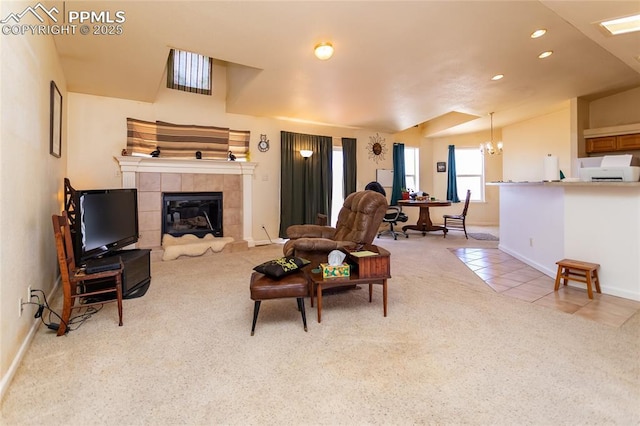tiled living area with baseboards, an inviting chandelier, a tiled fireplace, carpet, and recessed lighting