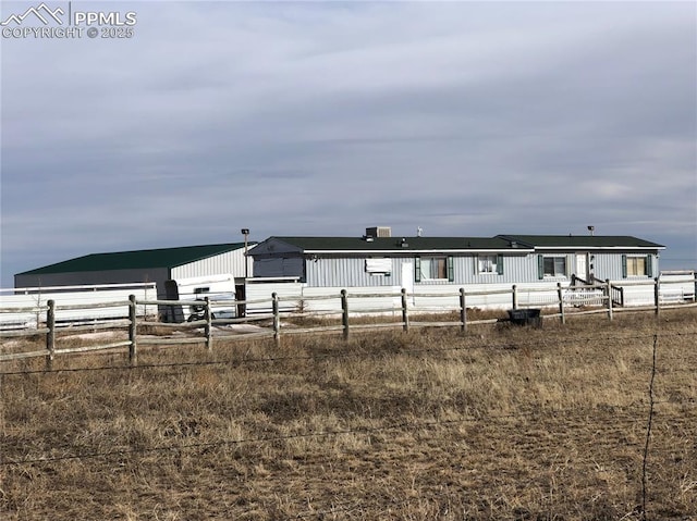 view of front facade with a garage and fence