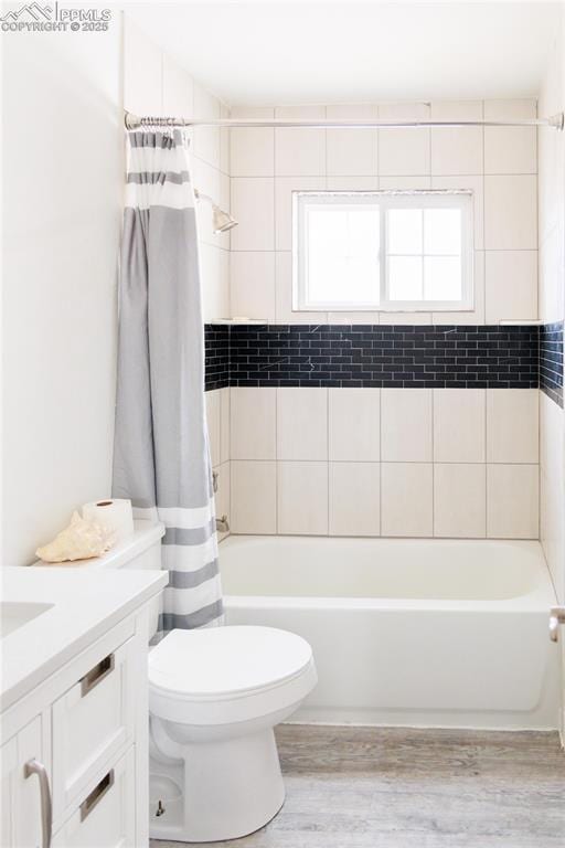full bathroom with shower / bath combination with curtain, toilet, vanity, and wood finished floors